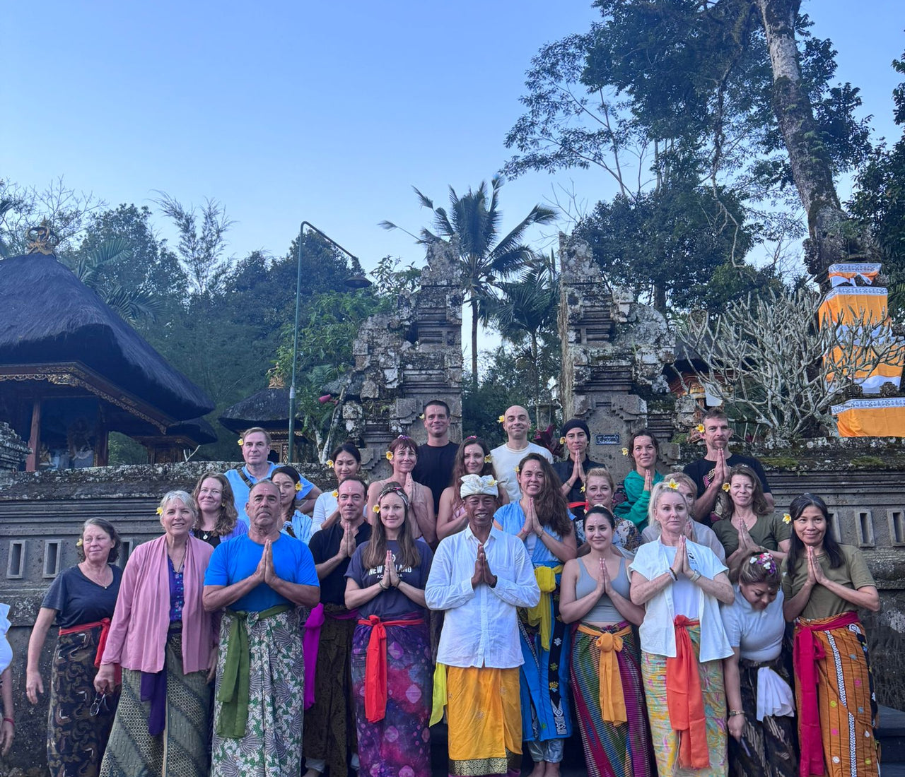a group of people posing for traditional Balinese ceremony