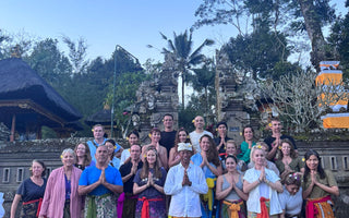 a group of people posing for traditional Balinese ceremony