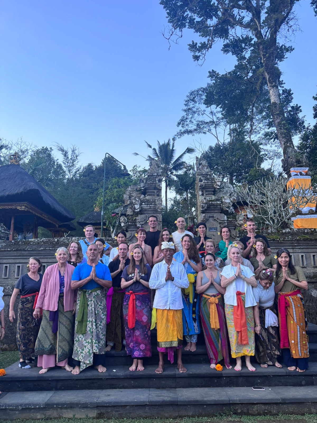 a group of people posing for traditional Balinese ceremony